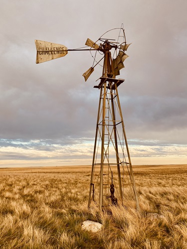 An old windmill in a field